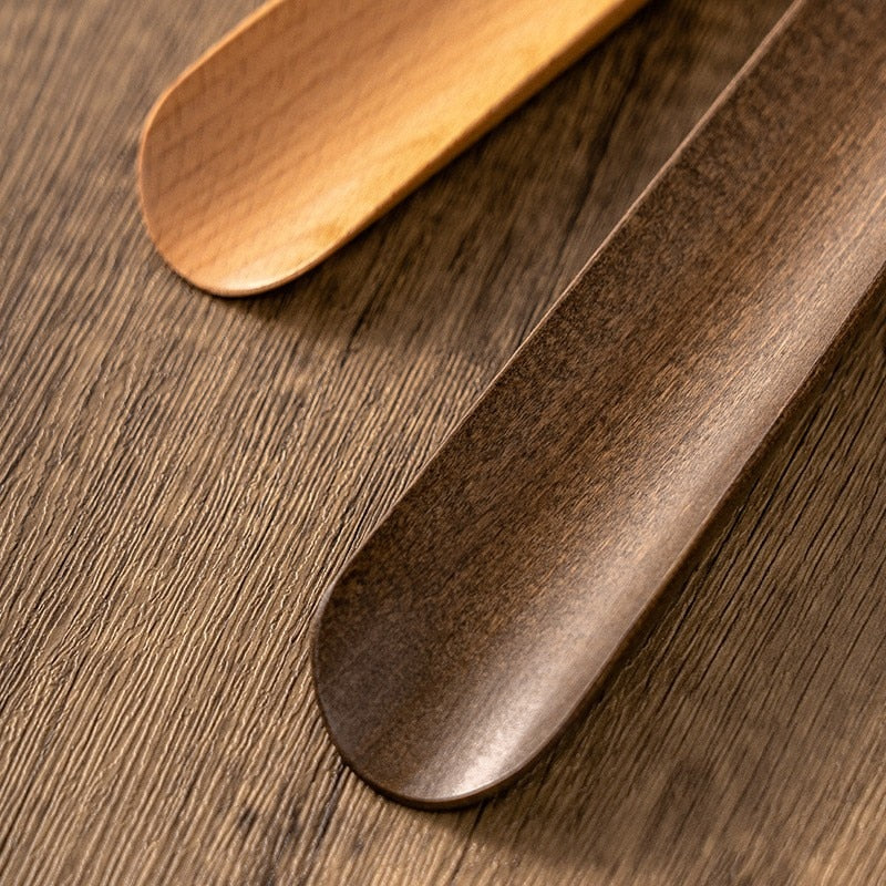 Long handled shoe horn made of solid wood, measuring 50 cm, designed for effortless shoe wearing and added comfort. 1